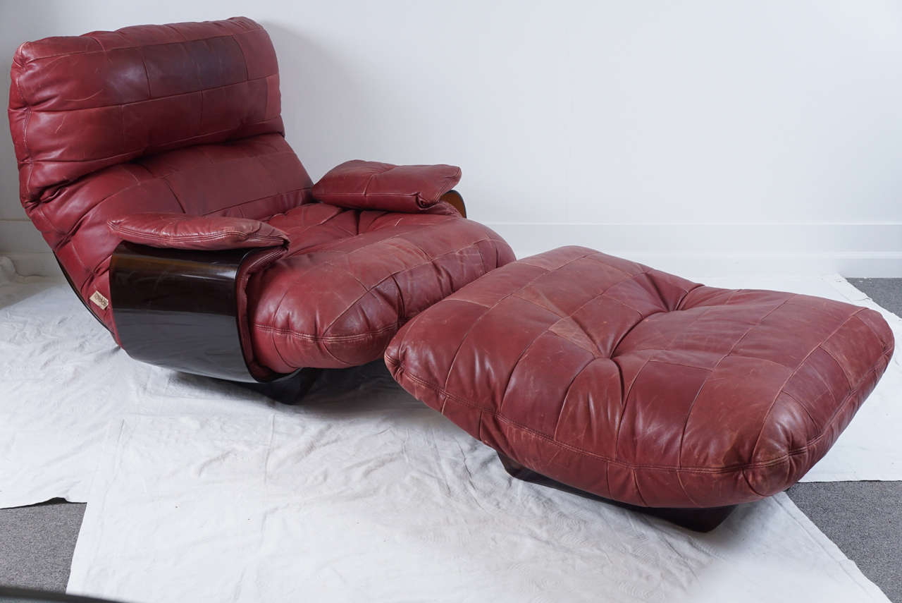 Another favorite of mine.
Michel Ducaroy perspex and leather lounge chair and ottoman for Ligne Roset.
The color is a merlot. 
Sits low and very comfortable, you will never want to get up!