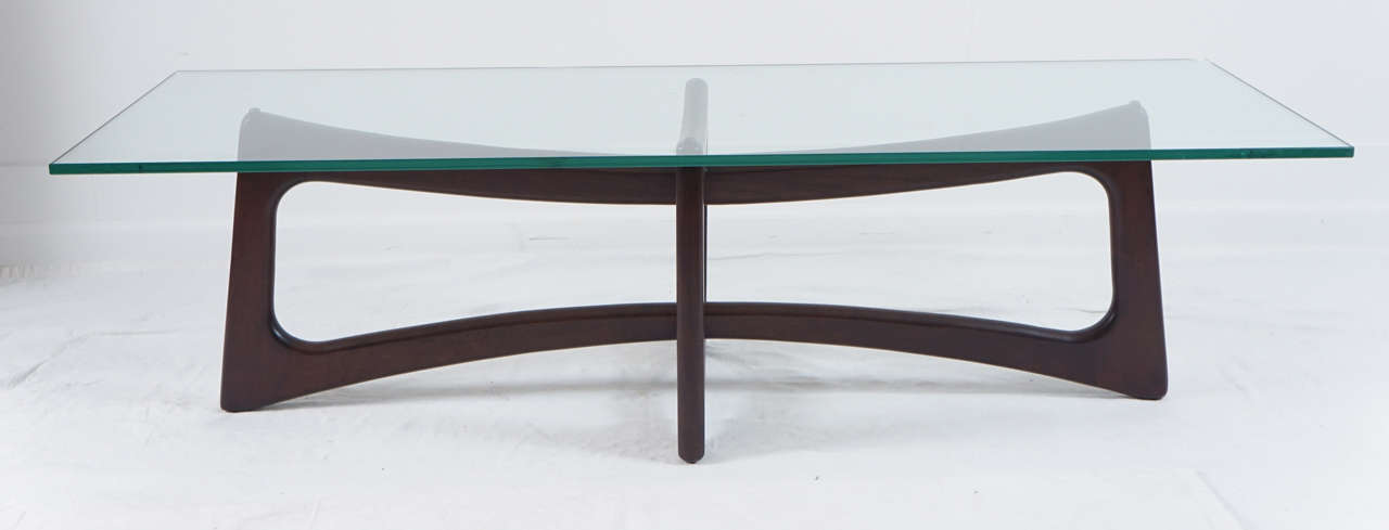 known as the bow-tie coffee table.
this table has been updated with a dark walnut finish.
the glass can be changed to suit your needs.
a surfboard shape or oval glass will work well.