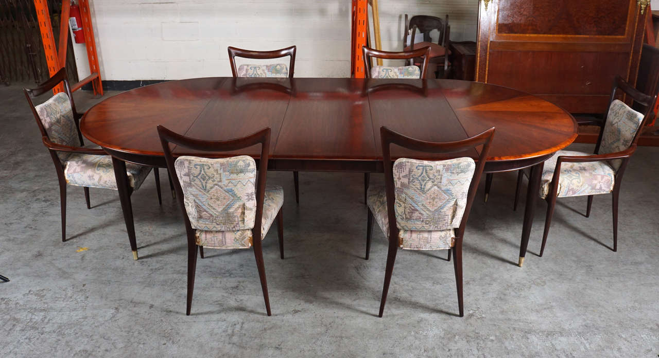 This is a stunning find!
A complete dining set designed for the hotel Bristol, Merano, Italy.
10 chairs with mahogany frames and upholstered seats.
The table has a stunning pie cut wood design to the top surface.
Three large leaves and extra