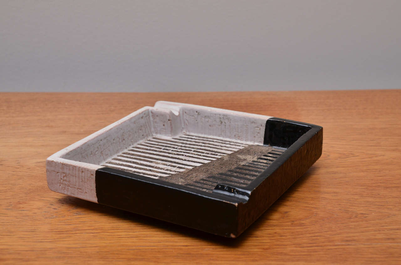Rectangular ceramic decorative object or ash tray with beautiful texture and natural black, white and brown color tones.
