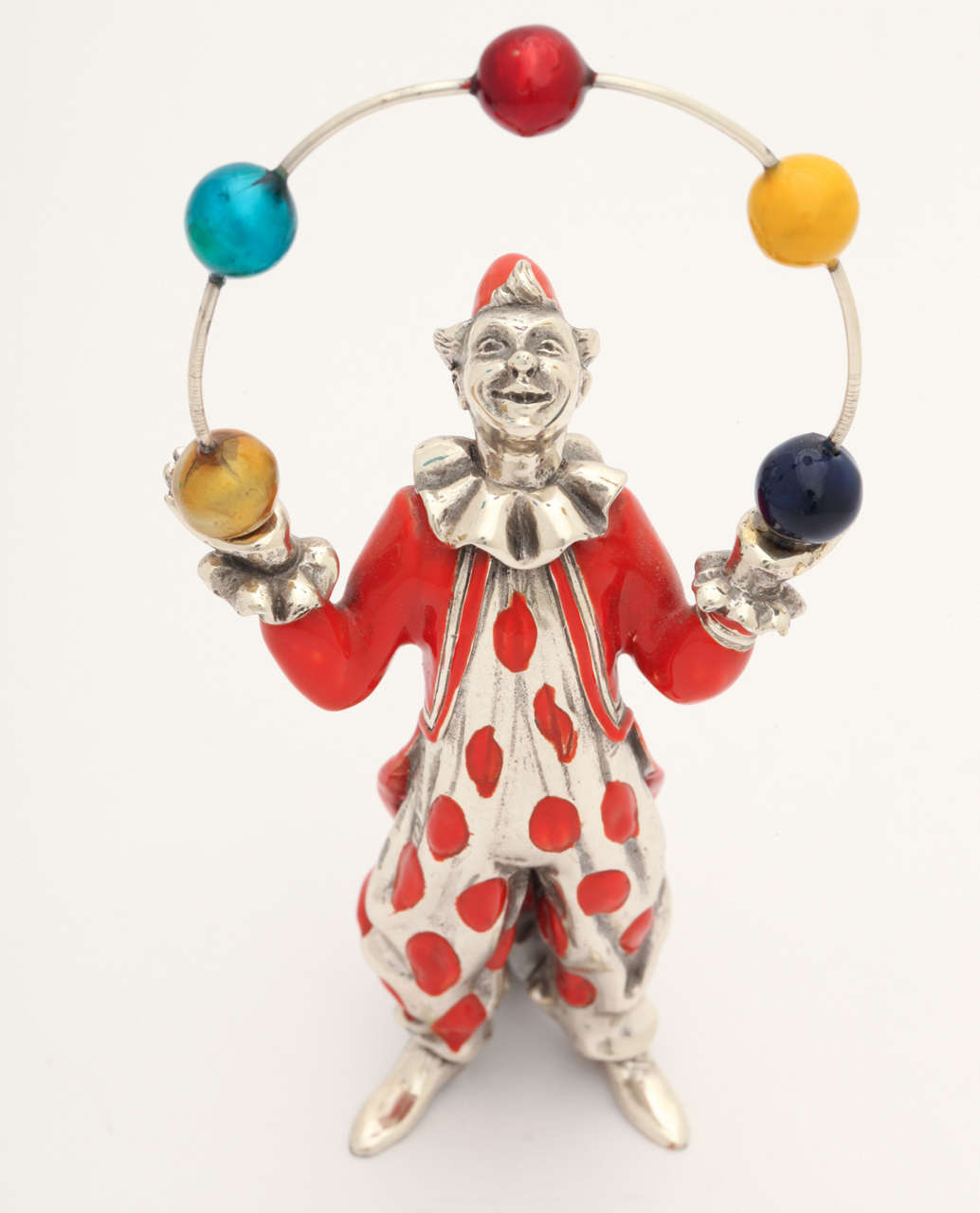 Whimsical polychrome sterling figurine of a juggling clown. Created by Gene Moore in the 1960's USA.

2