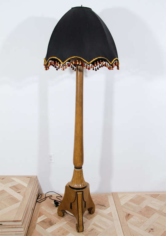 Early patinated and carved wood Art Deco floor lamp in the manner of A. A. Rateau.   

Base Height: 76”  -  Base Diameter: 16.5”