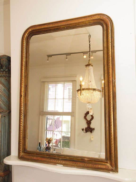 Classic and beautiful Louis Philippe Mirror.  Mid- 19th c., burnished and matte frame with criss cross molded edge, beaded inner border.  Remains of original mercury gilding and aged mirror.  Imperfections on this mirror only add beauty and