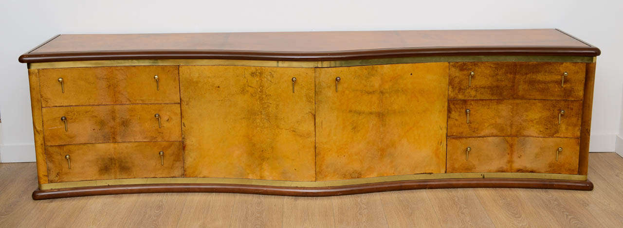 Rare, long (112 inches) wave front  chest of drawers, model Nettuno, by Luciano Frigerio. Wrapped with lacquered goatskin. Solid brass hardware. Six drawers and two central compartments.Exceptional craftsmanship.

THIS ITEM IS LOCATED IN MANHATTAN