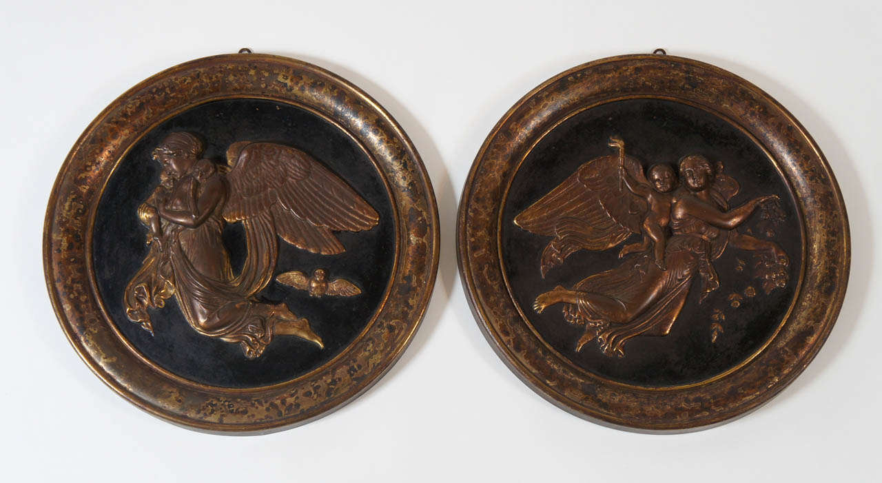 Beautiful pair of c. 1825 repoussé sheet-brass roundels depicting Danish sculptor Bertel Thorvaldsen's 'Day' and 'Night'. As opposites they represent the two halves of a day, and together symbolise the wholeness of a day. 'Day', oriented right, is