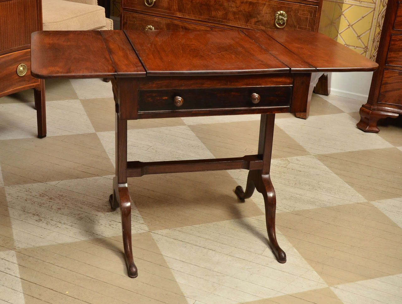 19th Century English Regency Mahogany Dressing Table

This unusual table has a fold out mirror framed with mahogany and two sides which open out and a working drawer.  When the mirror folds down the top of the table is beautiful solid mahogany.