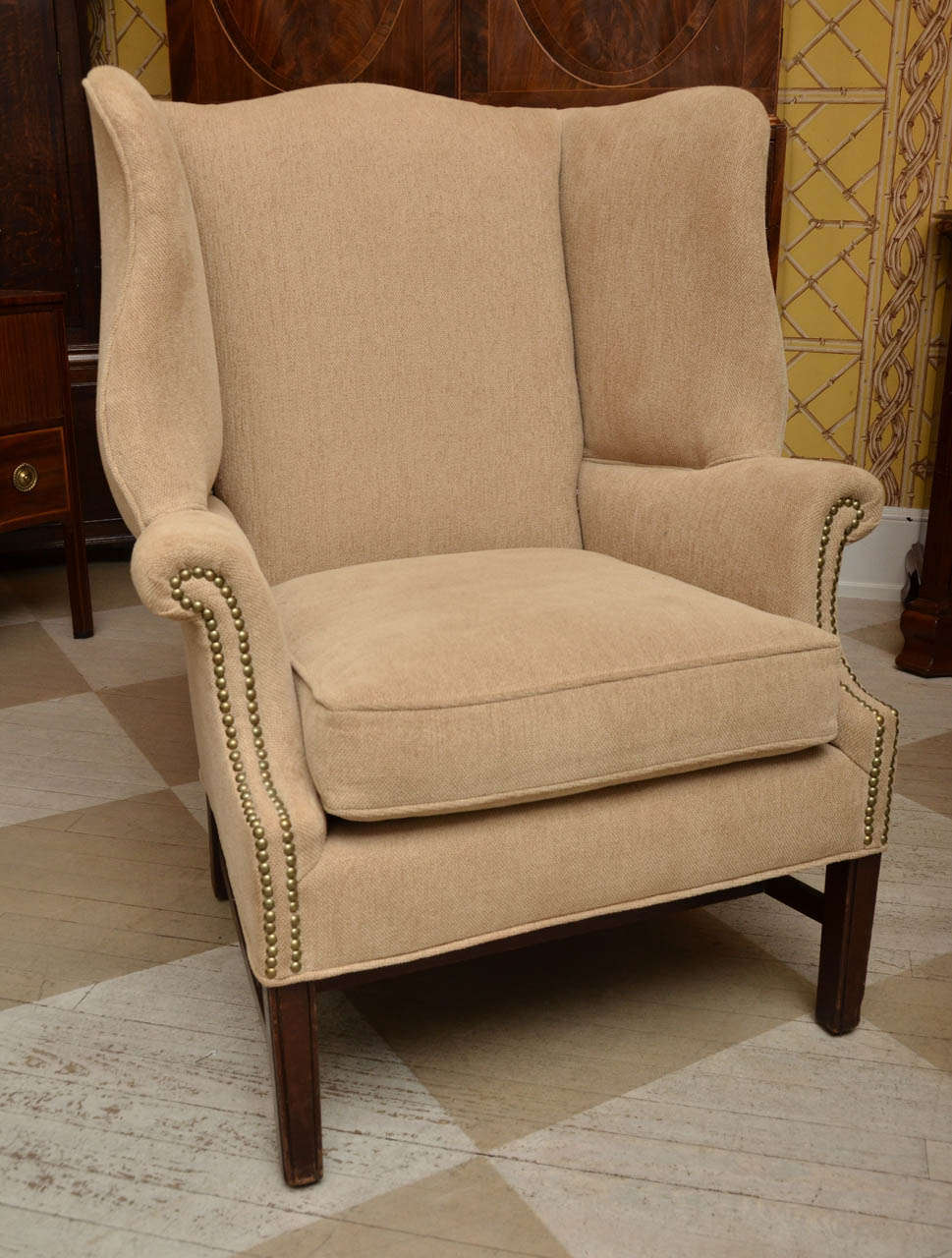 English Georgian Style mahogany wing chair. There is another chair almost exactly the same. These chairs came in as a pair and we upholstered them in the same fabric and show them as a pair. Posted is only for sale, since there are very slight