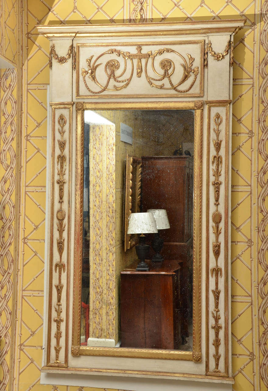 Pair of Swedish Regency Style painted gilt wooden carved mirrors.