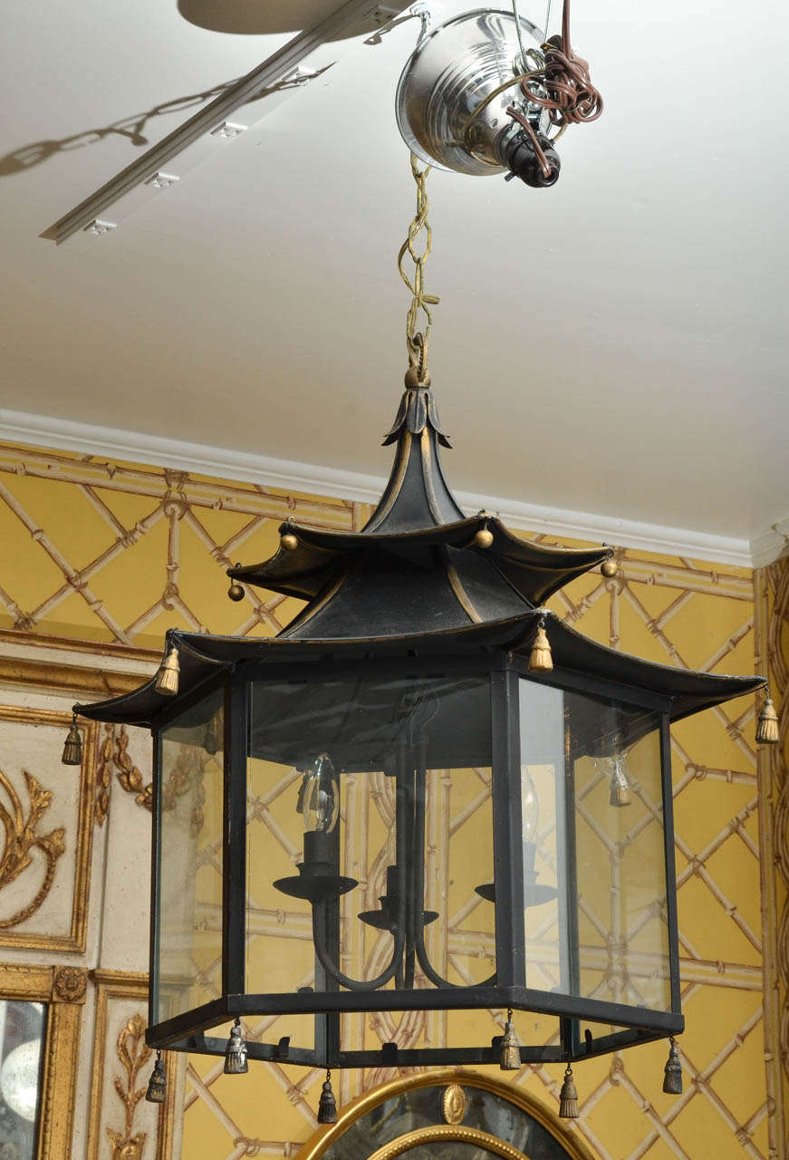Pair of English Regency Style black tole pagoda lanterns with tassels.