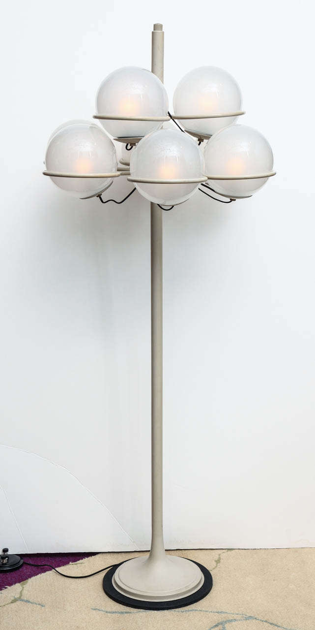 Rare #1094 floor lamp by Gino Sarfatti for Arteluce.  Part of a great series by Sarfatti, this floor lamp features nine lights, each surrounded by frosted Murano glass globes. This example retains its original off white color paint, original globes