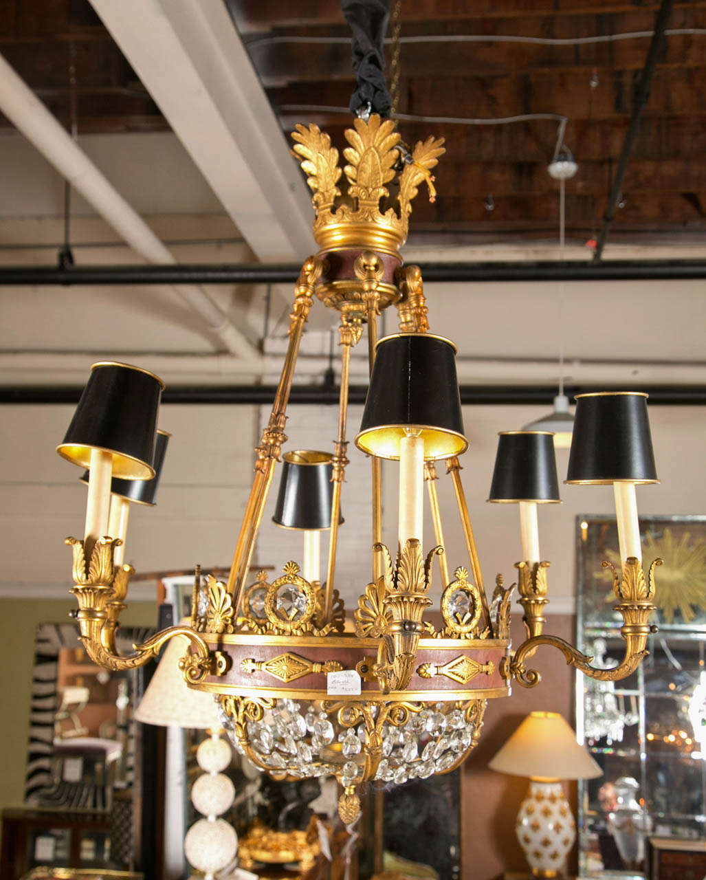 A finely cast six light French Empire Chandelier. The lower crystal and bronze basket supported by a bronze and brown metal apron having six arms with lights.