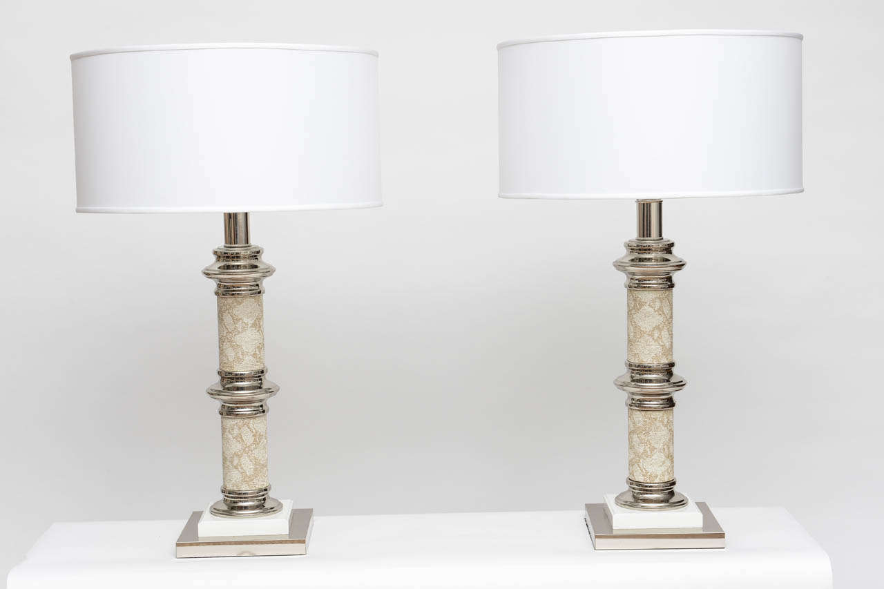 Pair of chrome, lacquered wood, and faux snake skin column lamps. Newly rewired and fully appointed with nickel fittings. Bright and cheerful, these lamps make a great statement in a myriad of room settings. Sold as pair without shades which were