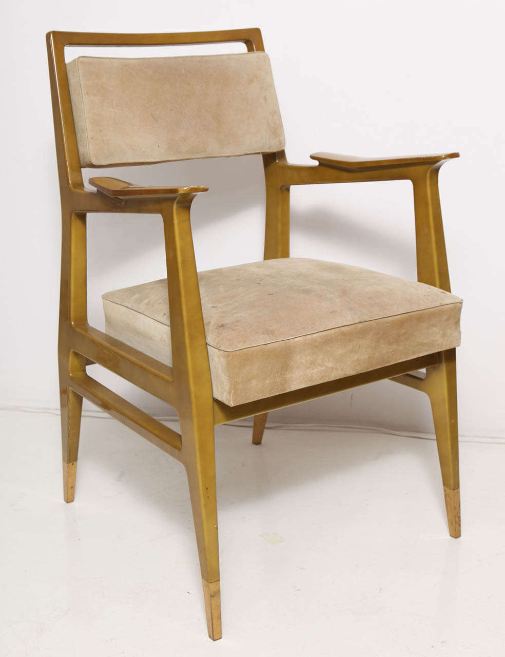 Raphaël Raffel (1912-2000).  Pair of armchairs in dark goldenrod lacquered wood raised on tapering legs with brass sabots. Suede-upholstered seat and back.  French, circa 1950's.