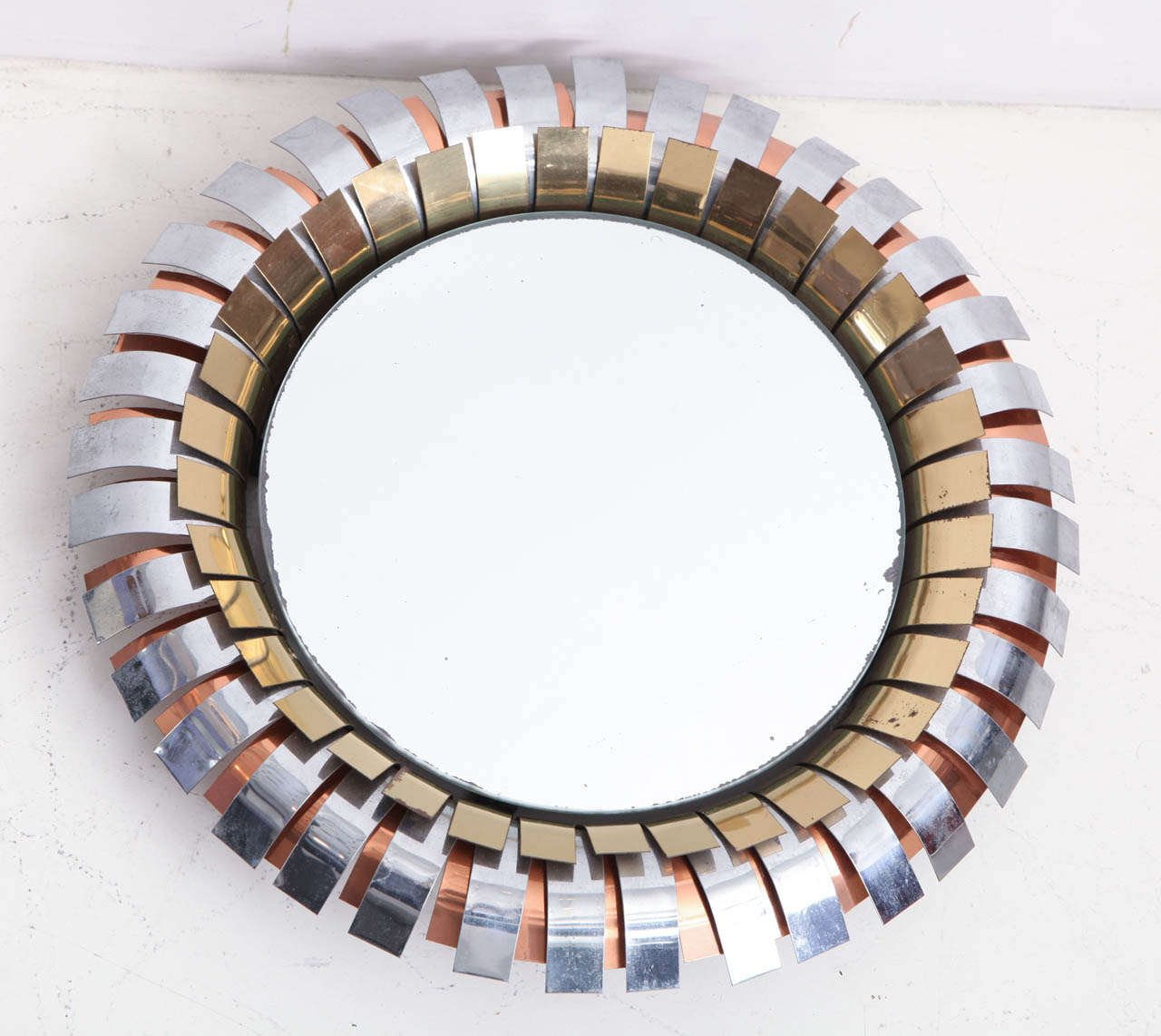 CURTIS JERÉ
“Eyelash” mirror in brass, copper and chrome. 
Signed: C Jeré
American, circa 1970.