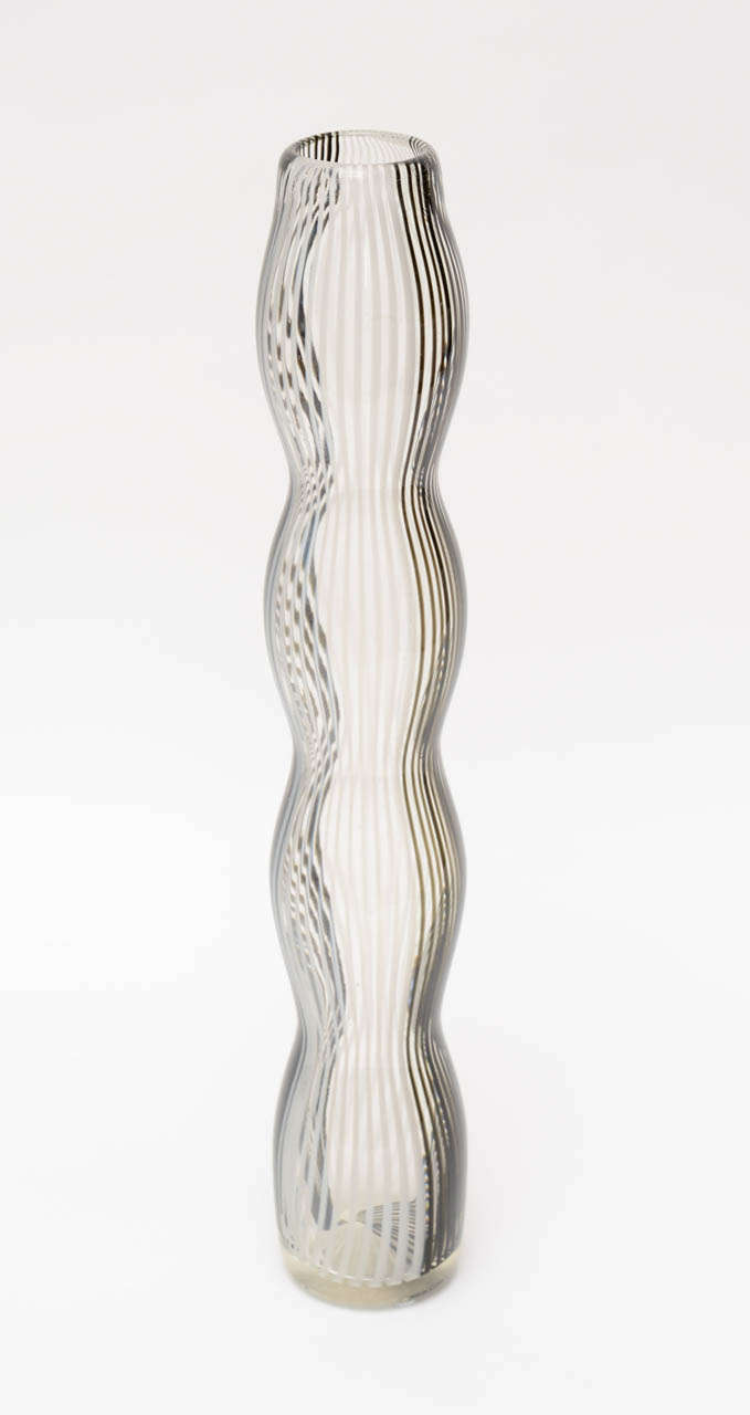 This wonderful undulating striped Italian Murano glass tall vase attributed to Dino Martens has hourglass curves. striped of white , black, brown gray rotate on sides. It has a wonderful lightness  and a great graphic quality.  It is different from