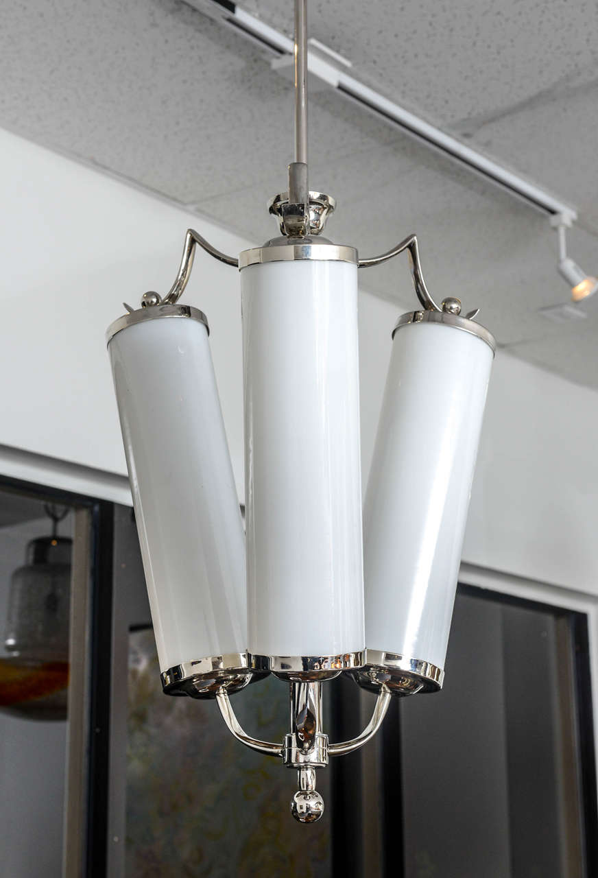 Very unique and unusual design for this pair of chrome and opaline glass tubes chandeliers. In the Style of Paolo Buffa.
One bulb in each glass tube (normal power).
Provenance Italia, Art Deco furnished home in Torino.
Wired for USA.