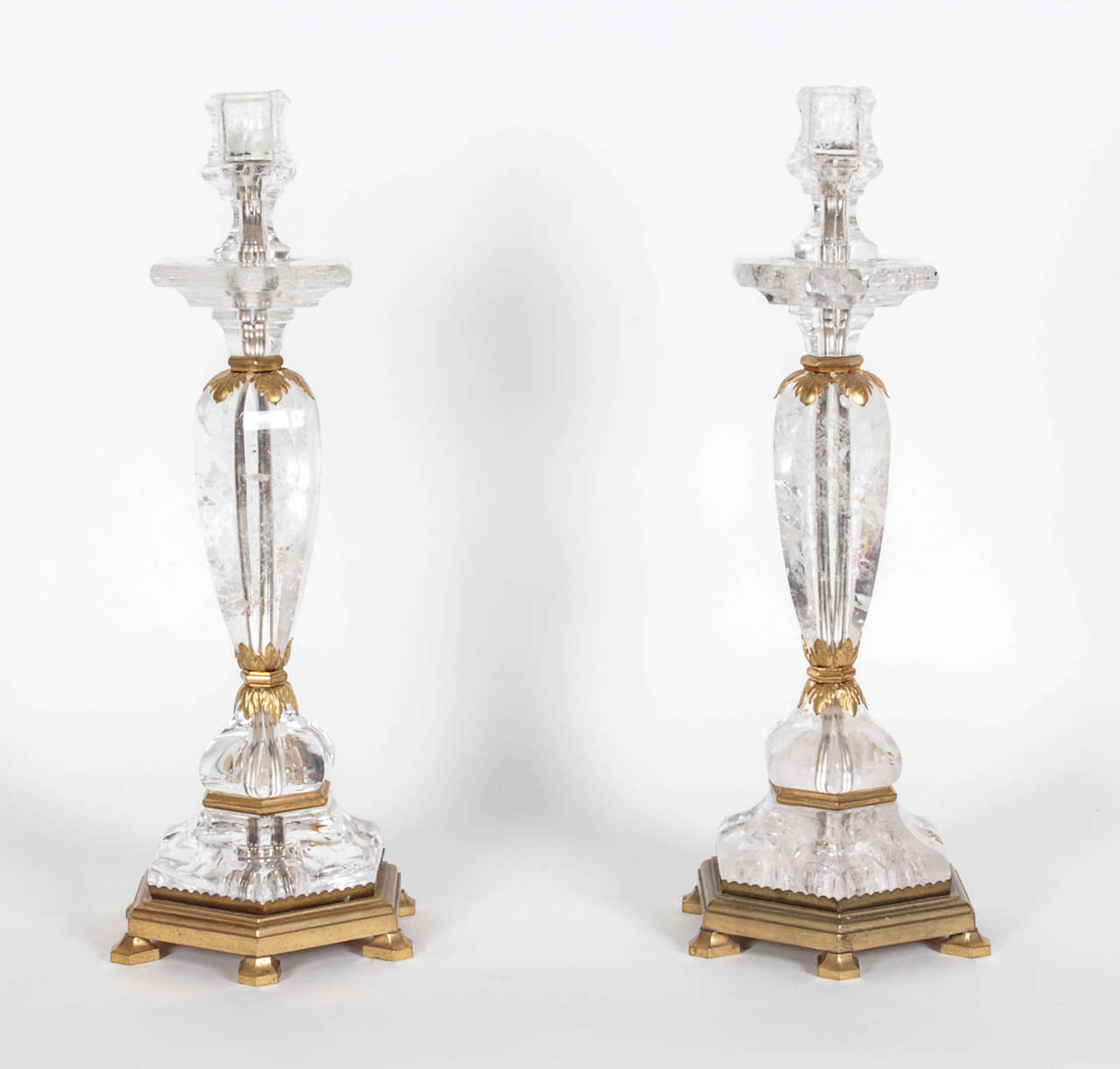 This exquisite pair of candlesticks was retailed by Bonzano, a Paris firm that specialized in ormolu-mounted rock crystal objects.  They have an interior channel to permit electrification as lamps. The model was featured in a 1951 article in 'Art et
