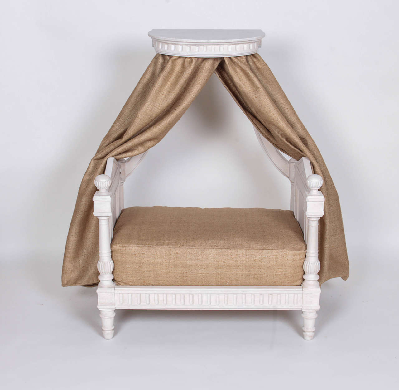 A Directoire period dog bed, with the original wood-and-cord mattress support, now upholstered in shantung silk.