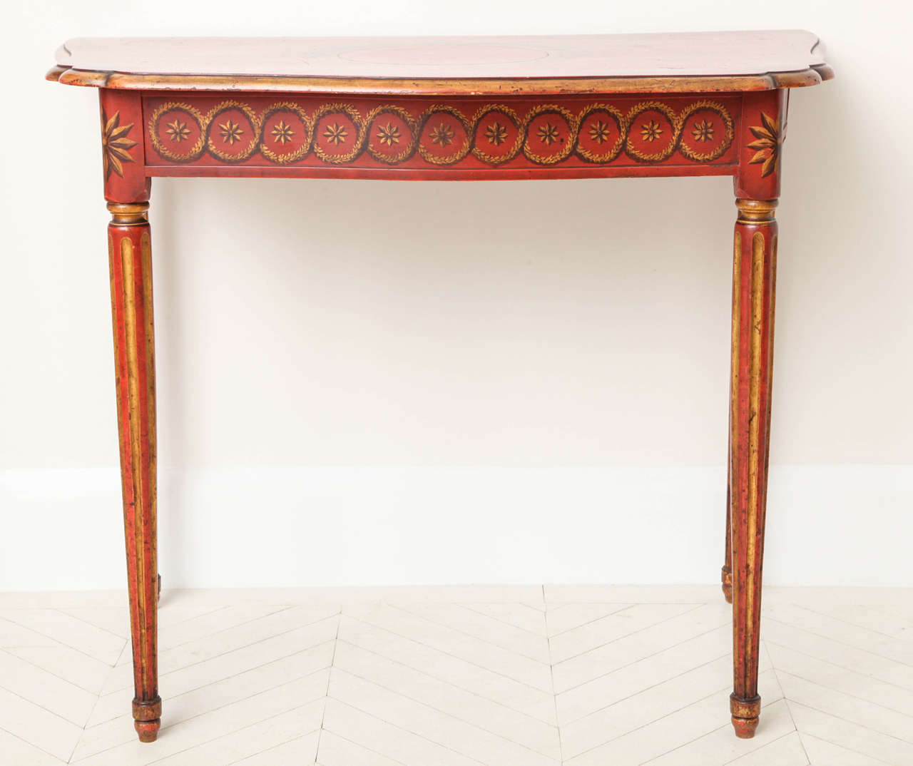 A 19th century Italian neoclassic polychrome and gilt-painted console table with shaped top, decorated frieze and stop-fluted legs, circa 1880.