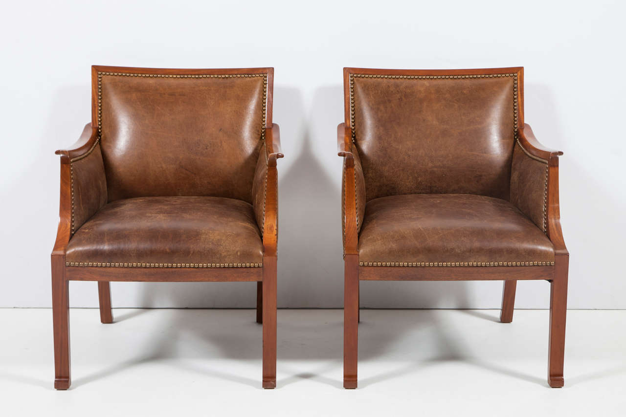 Frits Henningsen, Designed Circa 1934.  Pair of light mahogany armchairs with rectangular backs, outscrolled armrests raised on square legs ending with a scroll.

Literature: Danish furniture design for 40 years: the Copenhagen Cabinetmakers