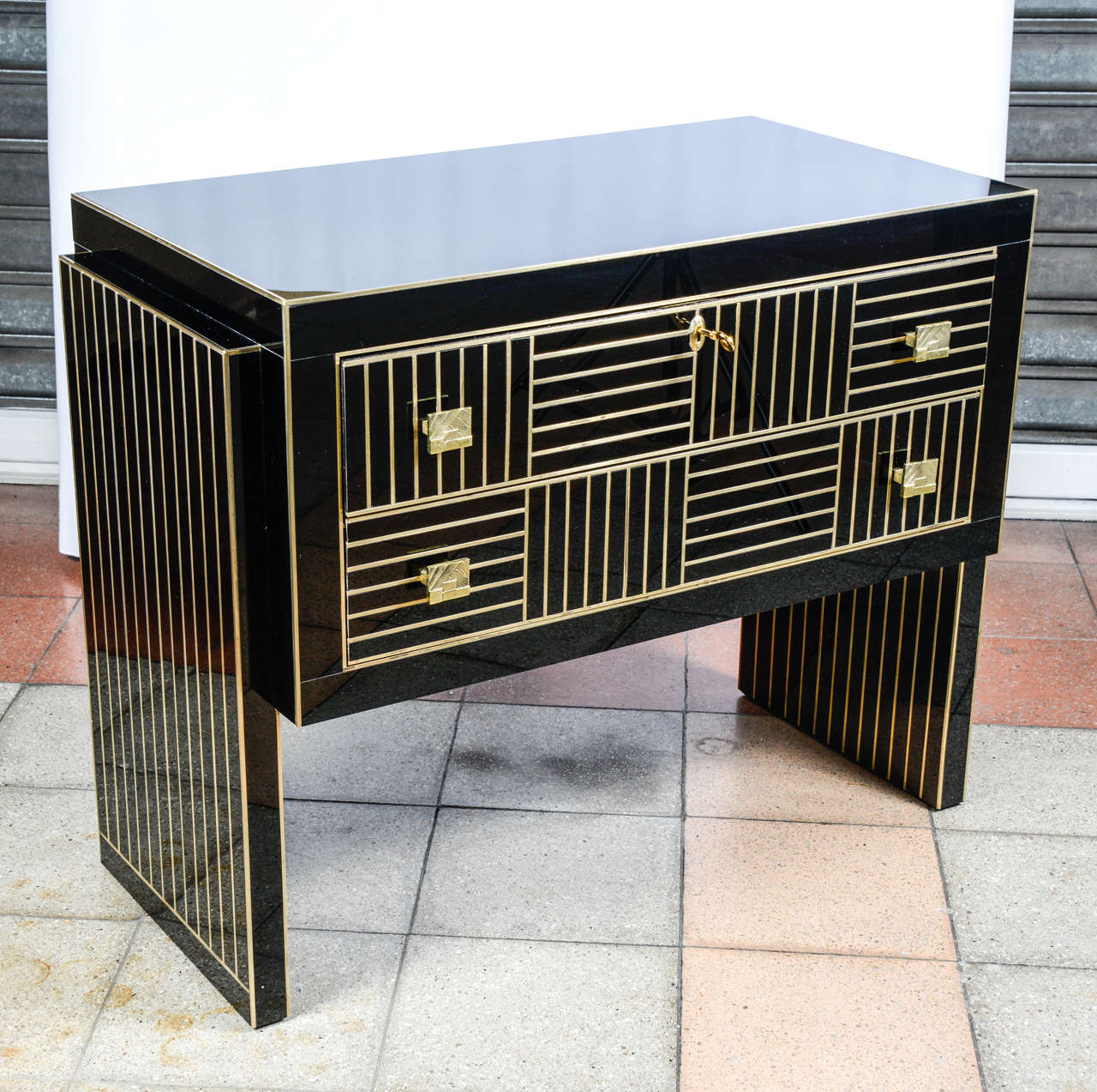 Commode all in black mirror and brass.