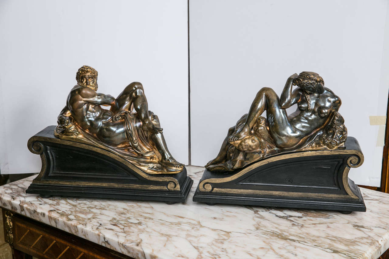 Extremely well cast and chased, this pair after Michelangelo' s design for the tomb of Lorenzo II de Medici. The figures representing Dusk and Dawn  are mounted upon shaped and painted wooden bases. Traces of old gold lacquer on the surfaces.  The