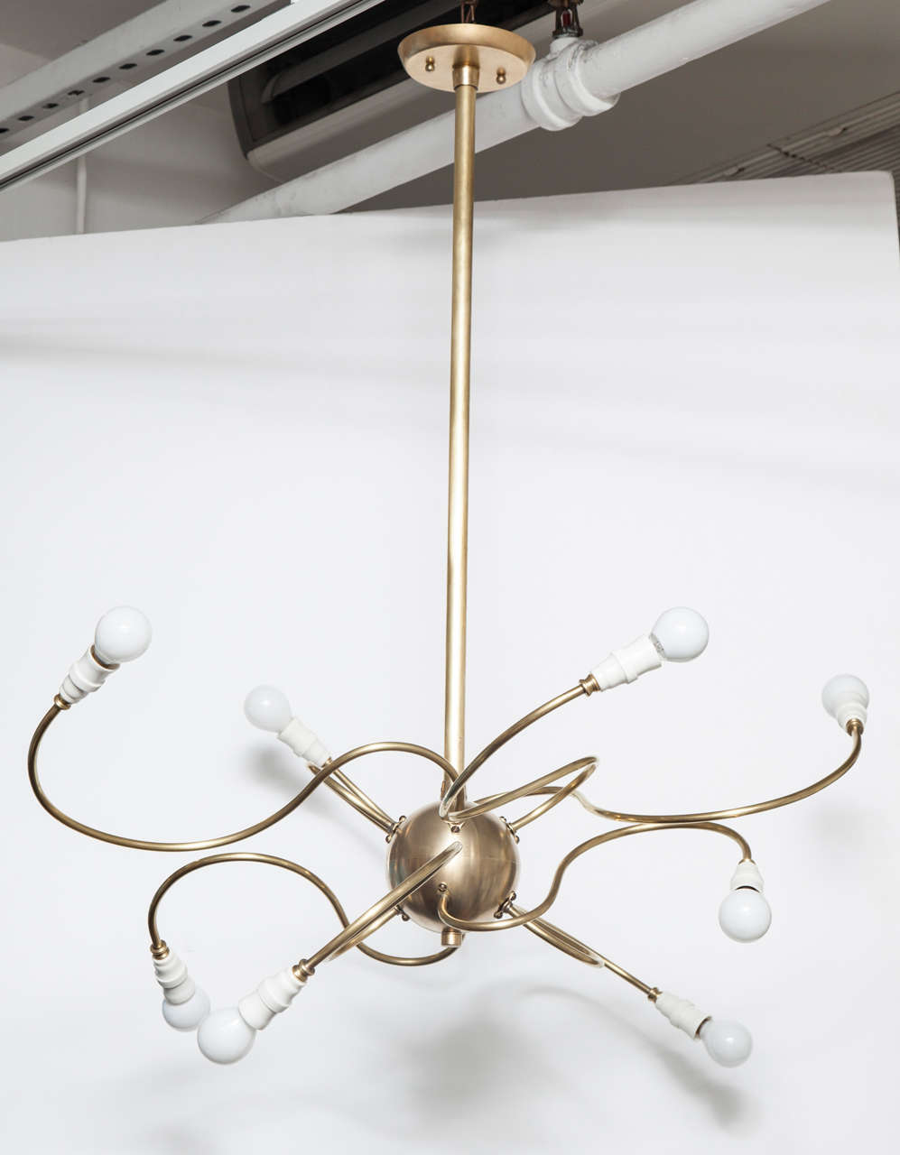 Available in custom sizes.  Made from vintage and new parts, this brass sputnik chandelier features eight (8) spider-style free-form arms.Includes  hanging stem and canopy. Takes eight (8) candelabra base bulbs, 60 watts max.

Dimensions as show;