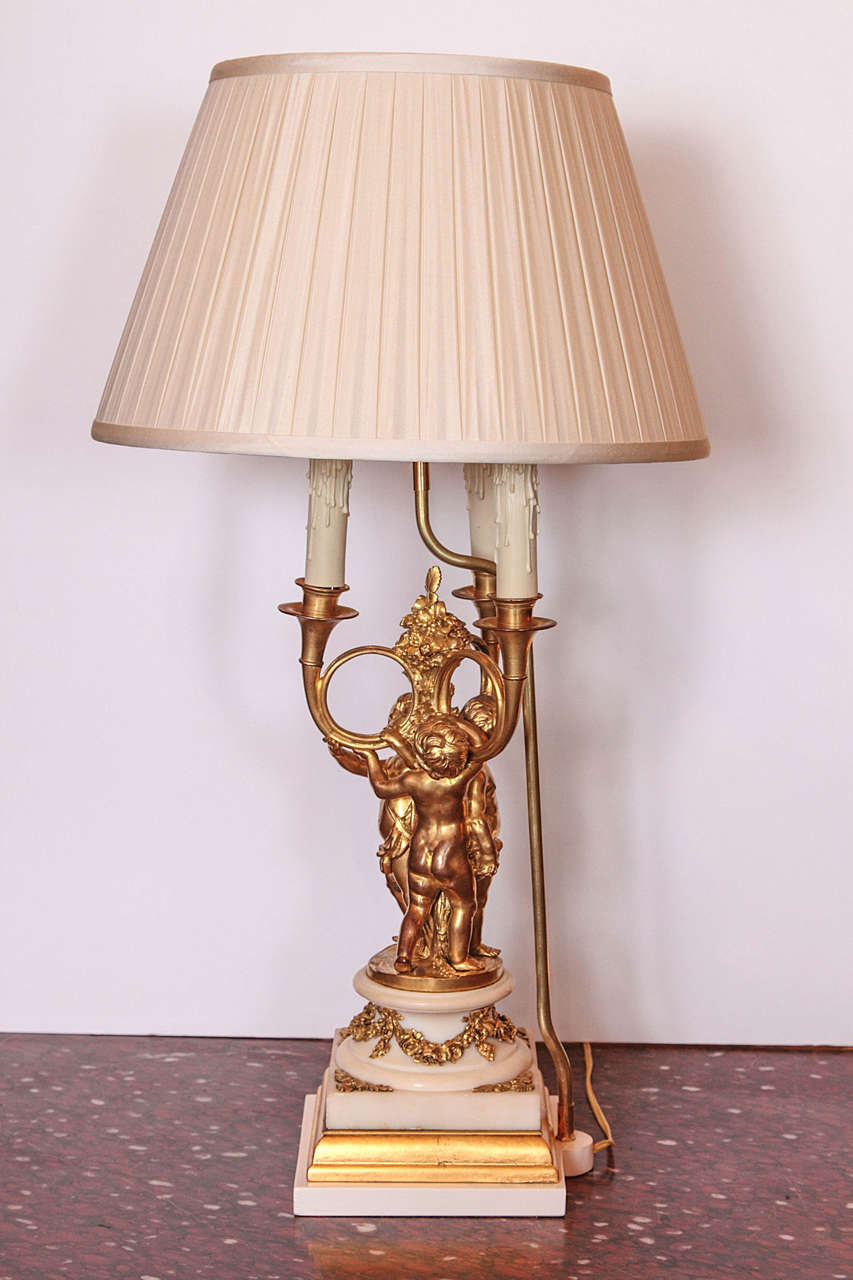 Pair of 19th c gilt bronze cherub lamps on marble bases