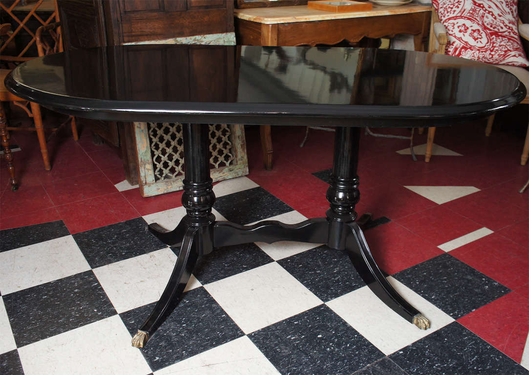 Black lacquered oval pedestal dining table.<br />
<br />
Keywords:  Regency style dining table, duncan phyfe dinging table, georgian style dining table.