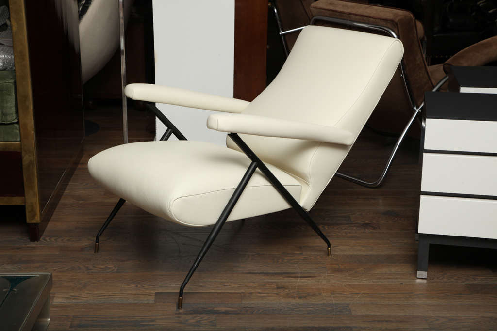 A very simple yet extremely elegant Italian arm chair from the 1960's, upholstered in creamy white cowhide with black painted metal legs.
The arms adjust backwards to a reclining position.