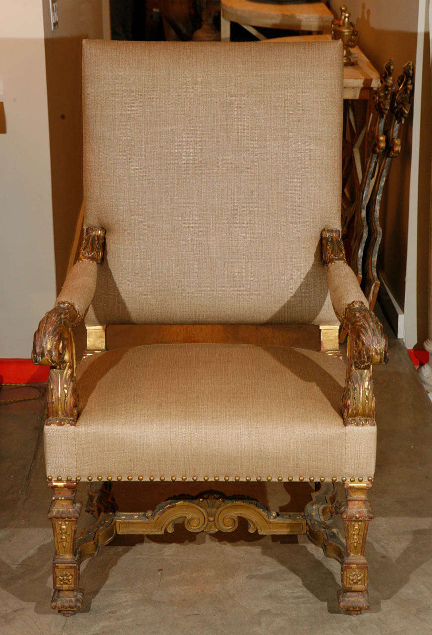 19th Century French arm chairs. The chairs feature carved giltwood. They have been newly reupholstered with Rose Tarlow linen and nail heads.