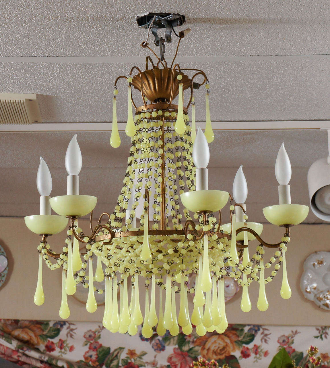 An unusual color graces this elegant chandelier, perfect for a foyer, bedroom or  dining room. The brass mounts frame the graceful bead work and the six arms hold matching bobeches and teardrop prisms. The condition is amazing and is near perfect