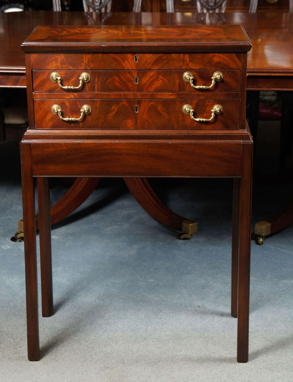 This elegant and beautifully made silver chest on stand is handcrafted by the renown furniture maker, Kittinger of Buffalo, NY. The Rococo style silver chest superbly copies the original late 18th Century English chest on frame from the Governor's