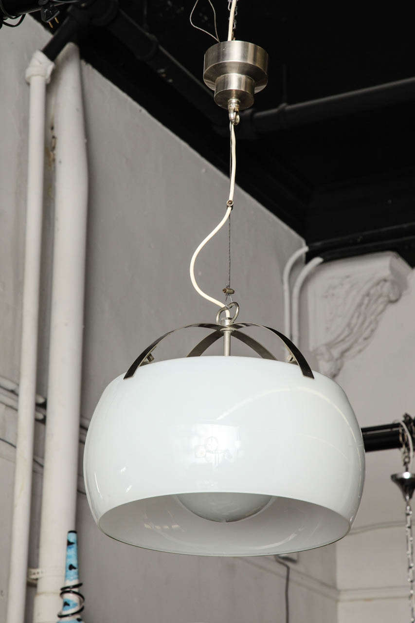 Exciting modernist chandelier called Omega, designed by Vico Magistretti and made in 1961 in Milan by Artemide.
Large white glass shade with a smaller round shade inside. Chrome fittings with adjustable cable wire to any length that you need.

