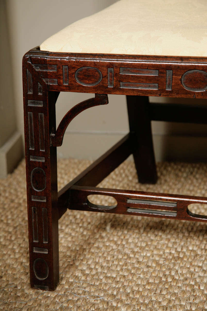 A rare Chippendale period Chinoiserie side chair. The legs, cross rail and sides all carved in intricate Chinoiserie fretwork as illustrated in Chippendale's section on Chinese Taste furniture in 'The Gentleman & Cabinet-Maker’s Director, 1754'. The