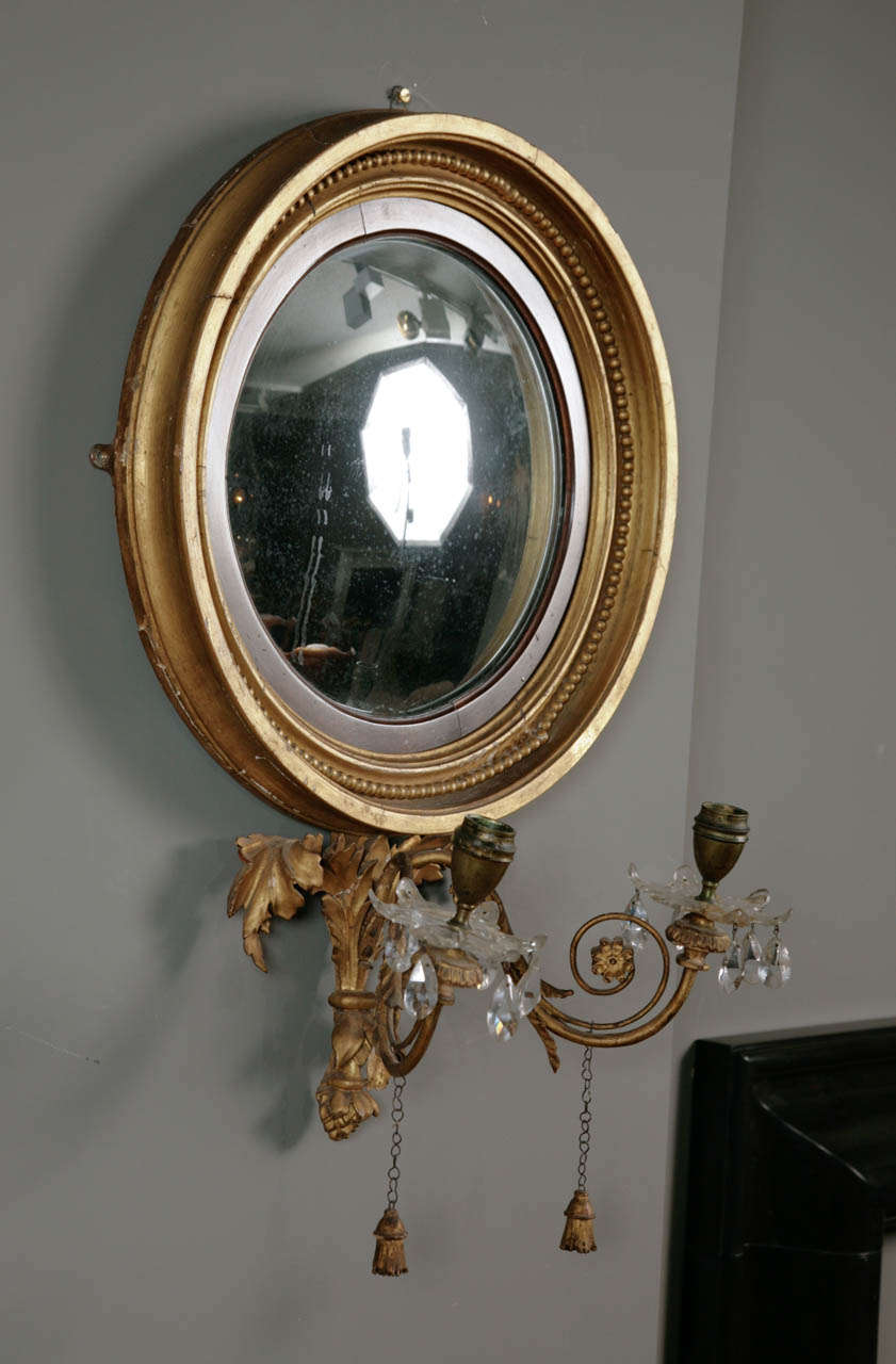 A Regency giltwood convex girandole mirror.