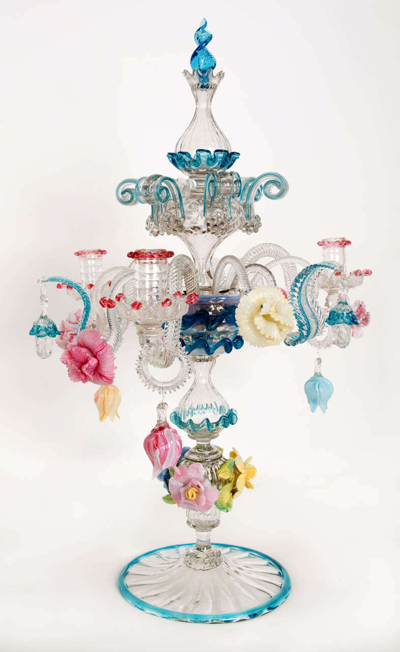 A rare complete handblown beautiful multi-colored glass candelabra made in the well known glass studios in Murano -Venice in the late 19th century.  The delicate stem on a round base with a blue rim on which are placed some flowers. In the central