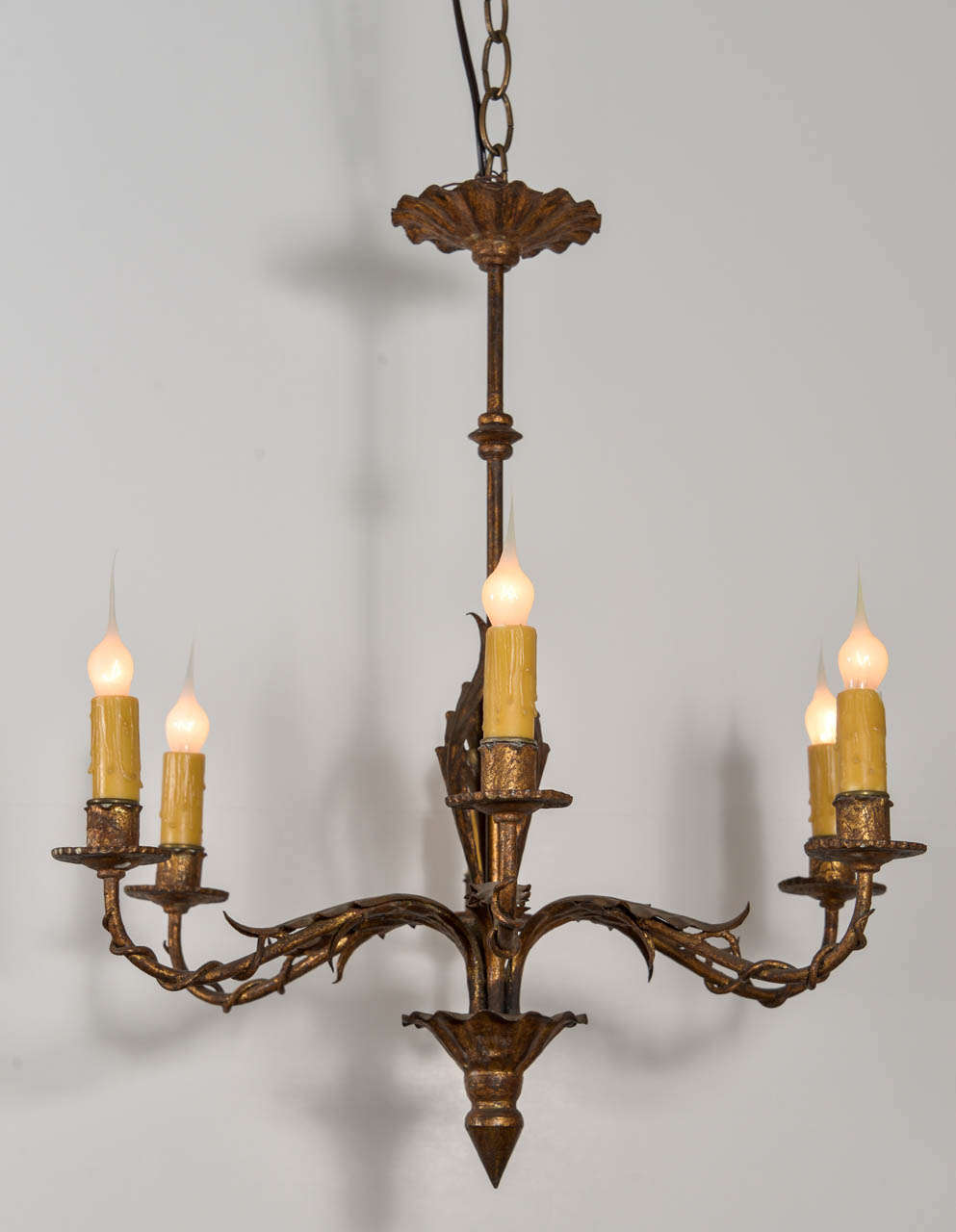 Gilt iron six-arm chandelier, newly-wired with extra chain, canopy and twisting vine and acanthus leaf decoration adorning each arm.