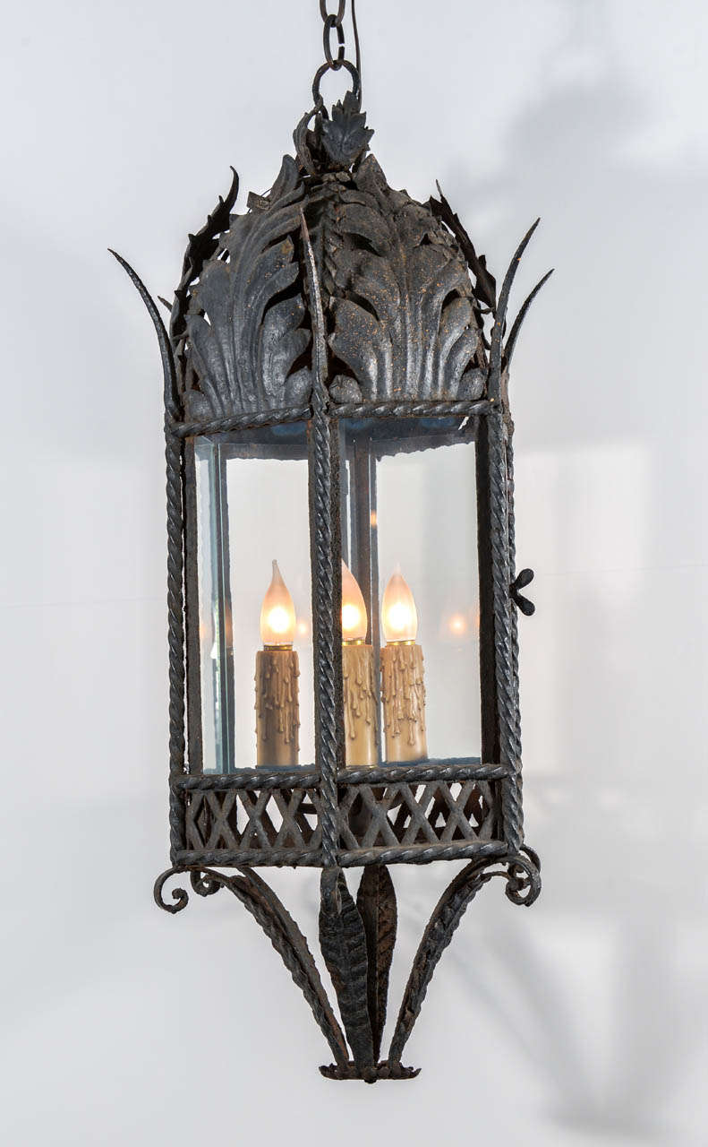 19th century hand-wrought iron lantern with three medium (Edison) base lights, newly wired with extra matching chain and canopy.