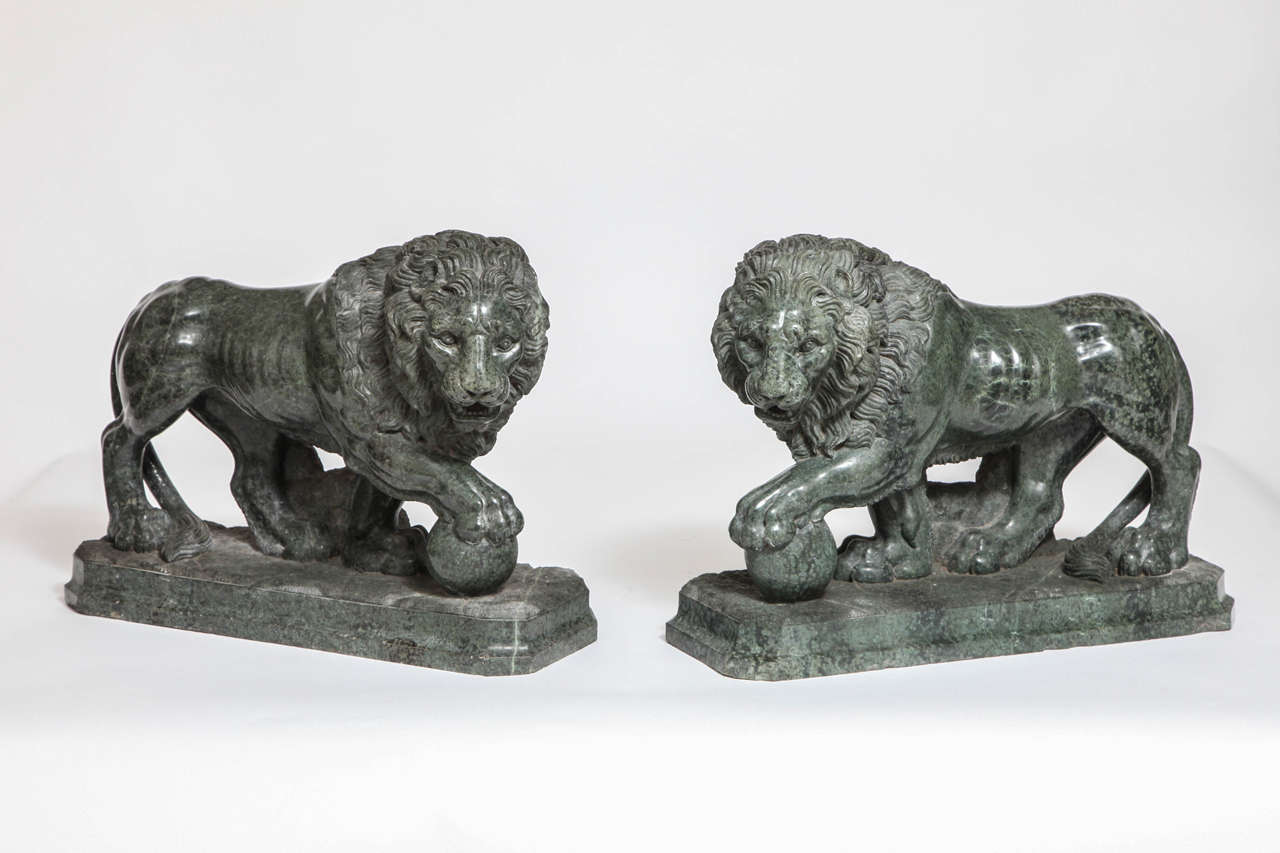 Pair of large and impressive Italian Verde Antico Marble Lions with Orbs, after Pietro Simoni Da Barga's famous Renaissance Medici Lions, which are modeled after the antique. Pair of statuesque Marble Lions balancing on orbs. Each lion is finely