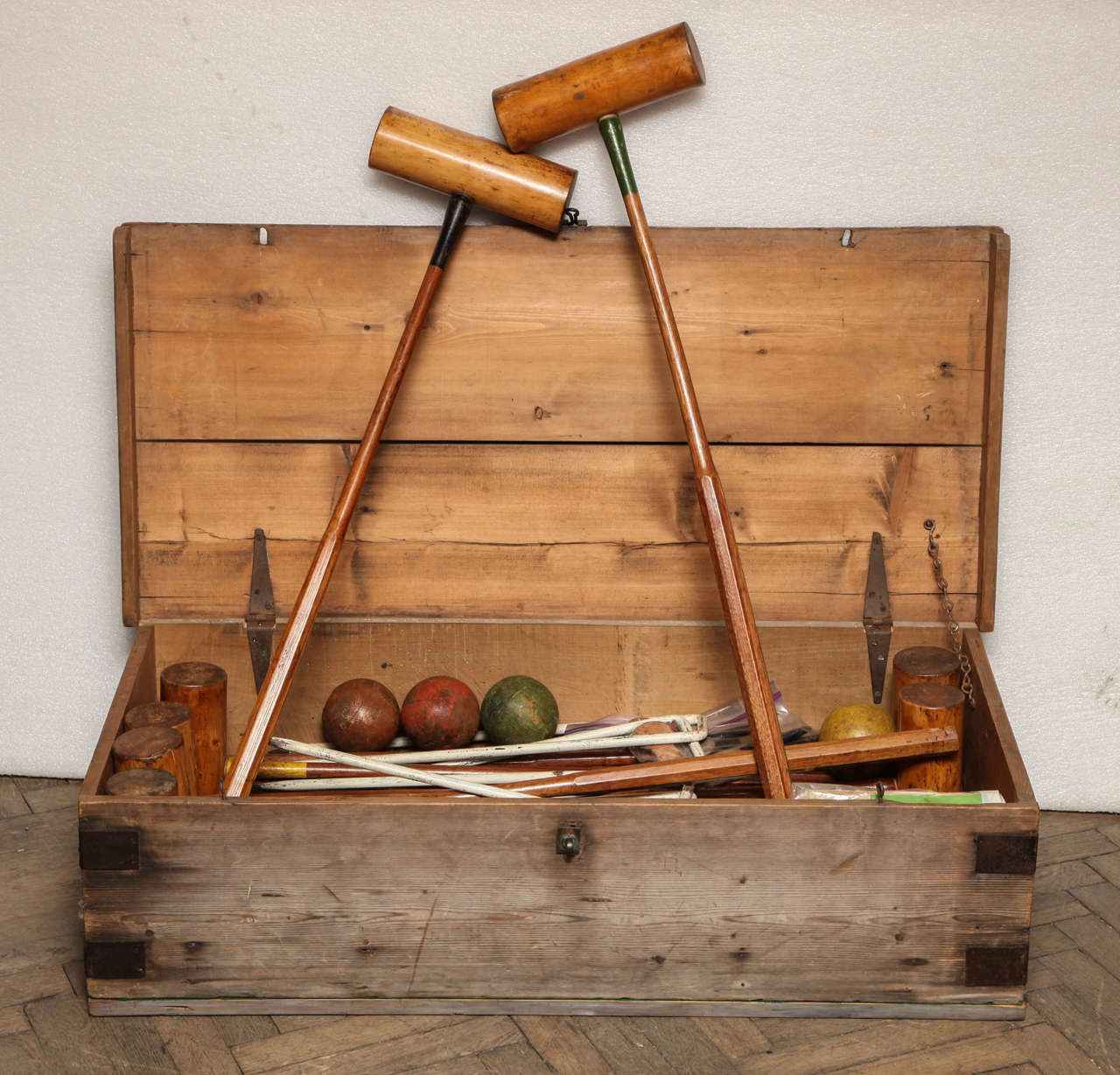 Antique croquet box with full croquet set included. Beautiful colors from original manufacturing still visible throughout the set.