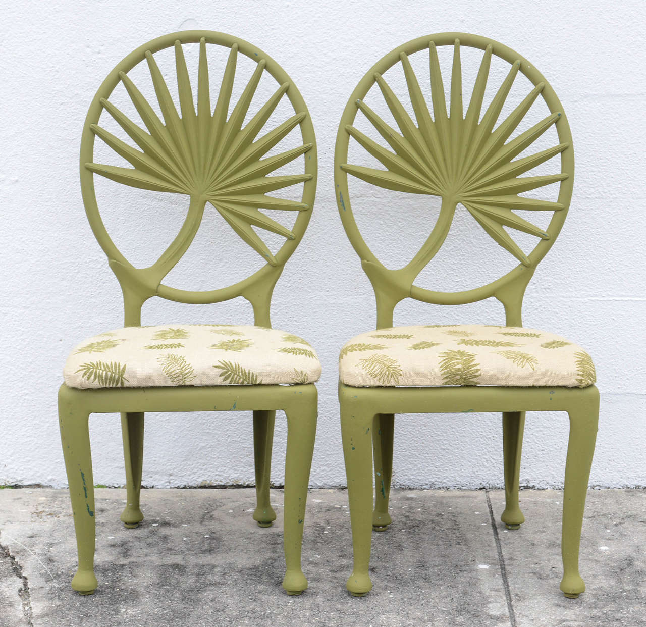 Unusual set of six painted aluminum chairs with palm frond motif. Very decorative.
