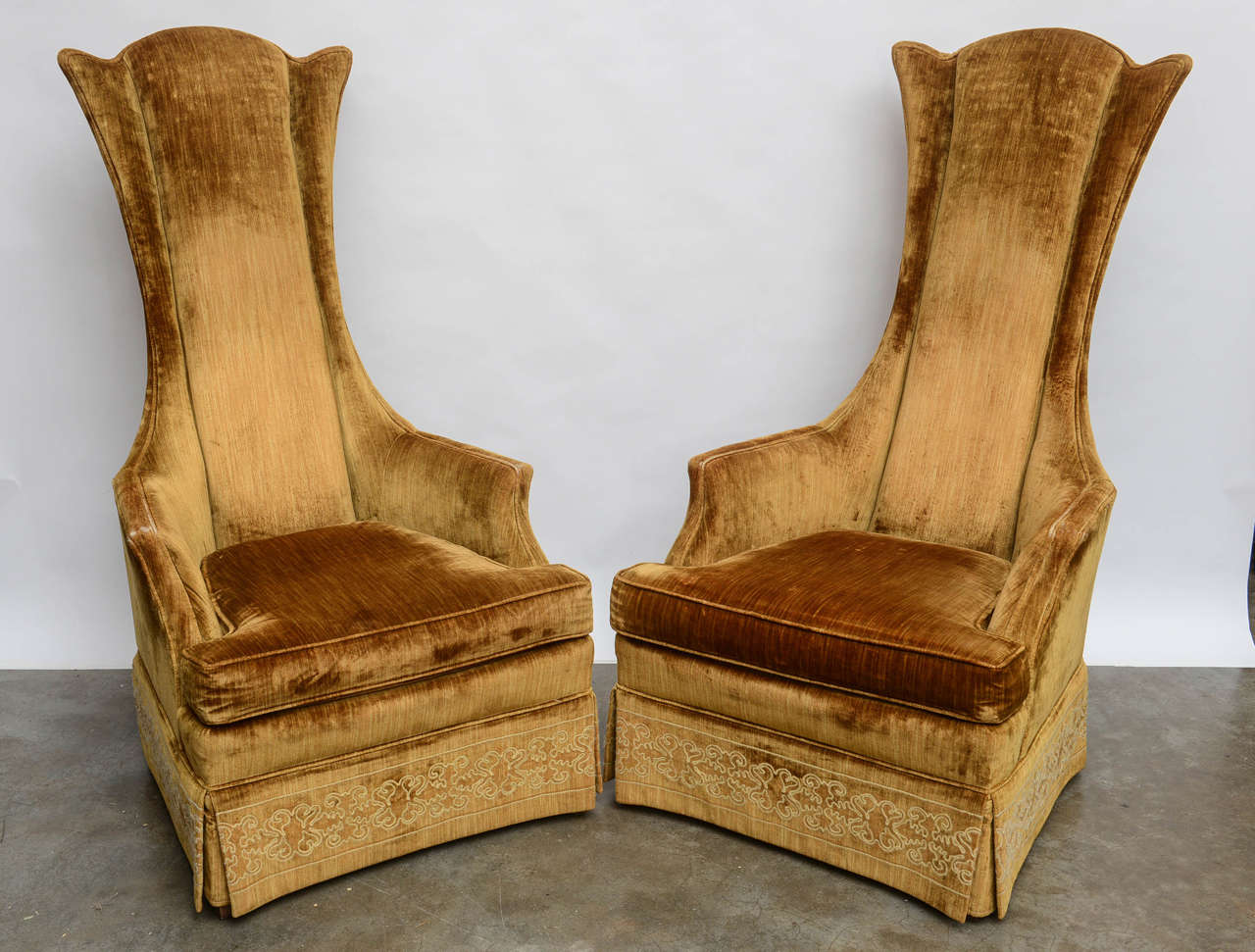 Impressive and chic pair of mid century modern stylized wingback chairs. Fantastic lines.
