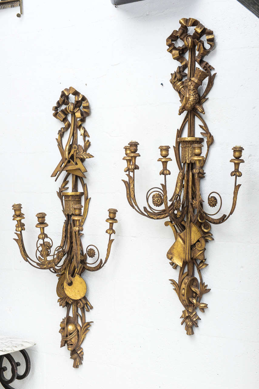 Italian Spectacular Pair of Oversized Giltwood Sconces Ornately Carved with the Arts