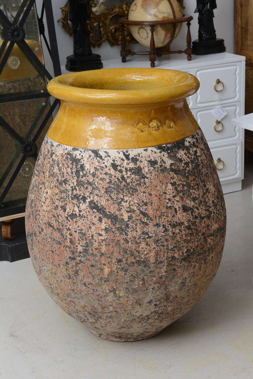 Large-scale pair of French ceramic garden pots with mustard yellow glazed tops and mottled pink and grey bottoms. The pots bear the original makers stamp see detail photo of touch marks.