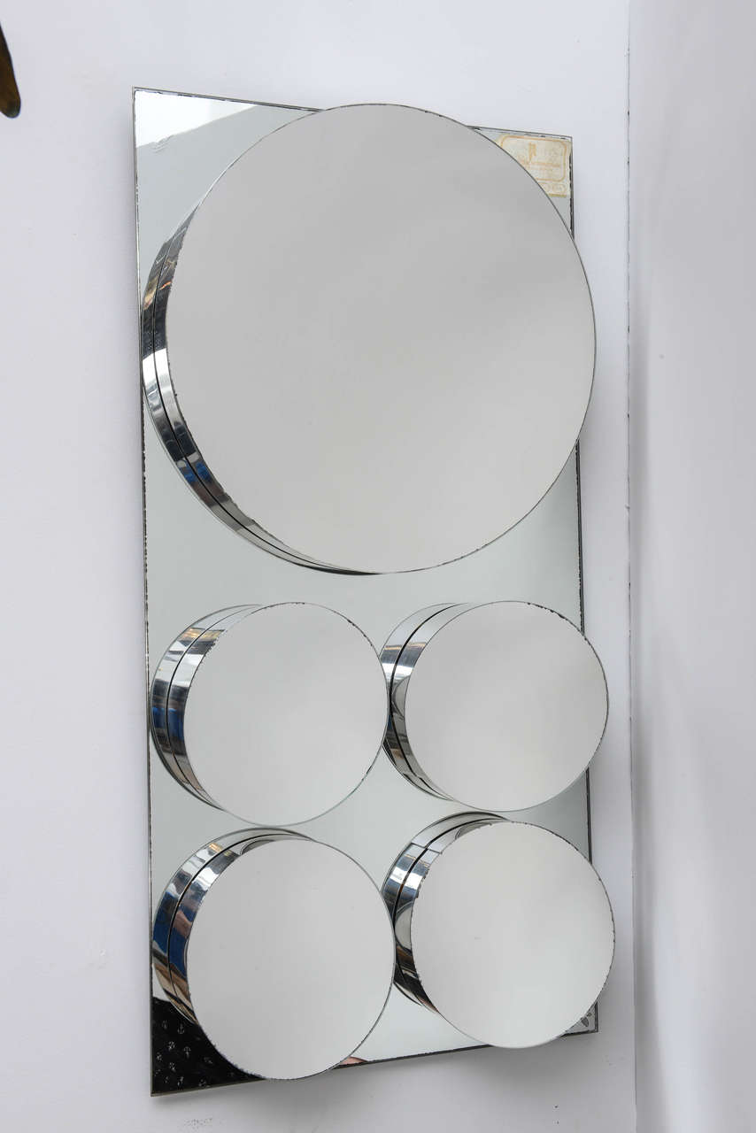 Sculptural and geometric mirror with multiple circle motif by John Leslie.