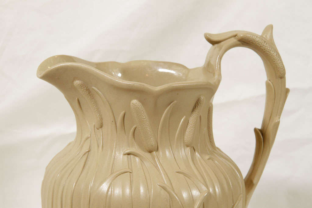 A Drabware jug with reeds molded all around. The reverse with an English registration mark for 1848.
This jug is part of our collection of 19th century English drabware and caneware.