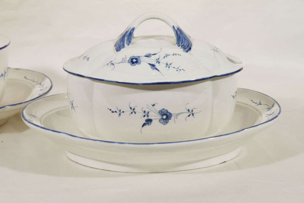 This pair of sauce tureens is 18th century French soft paste porcelain, circa 1770, decorated with a Blue and White Chantilly Sprig pattern. Each tureen stand has the Chantilly hunting horn mark in underglaze blue. In 1730 the Prince de Condé