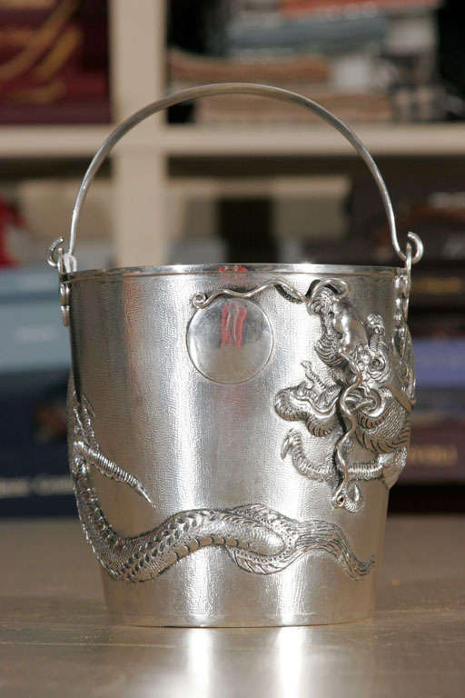 Beautifully hammered Chinese silver ice bucket with origenal tongs.<br />
Depicting a Chinese Dragon.<br />
Marked for Hongkong and 925 for Chines export