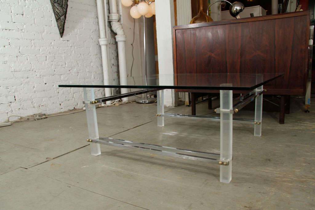 Lucite and glass coffee table with chrome stretchers.